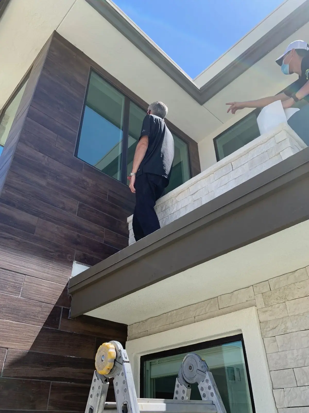 SunEez installer working on a second-story window